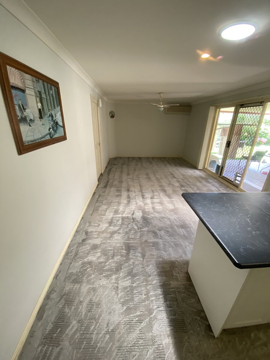 Kitchen and living area after floor removal and preparation