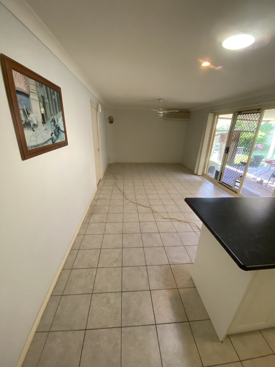 Tiled kitchen and living area before floor removal